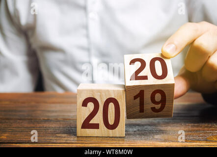 Two wooden blocks with numbers 2019 and 2020. The concept of the beginning of the new year. New objectives. Next decade. Trends and changes in the wor Stock Photo