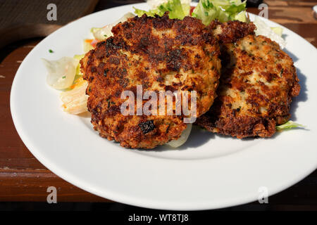 traditional tirolean flat bread dumplings kaspressknödel filled with mountain cheese served with green salad Tirol alm Stock Photo