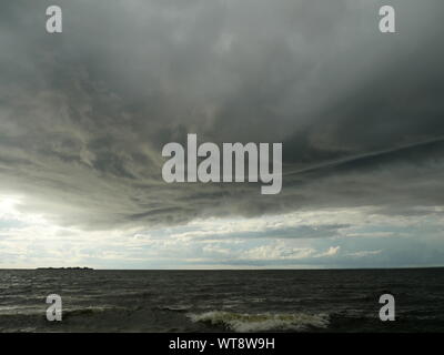 huge low dark clouds approaching the shore from the sea Stock Photo