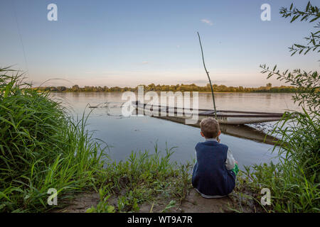 Boy fishing by the Vistula river, Poland Stock Photo