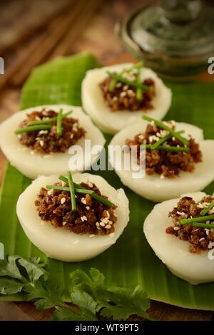 Chwee Kueh. Vegetarian dish of steamed rice water cake with preserved radish topping. Stock Photo