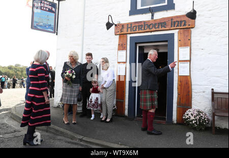 The Prince of Wales and Duchess of Cornwall, known as the Duke and Duchess of Rothesay when in Scotland, pay a visit to the Harbour Inn during a visit to the coastal village of Garlieston, Wigtownshire, where the port played an important role in D-Day preparations in 1944, in the testing of the Mulberry Harbours. PA Photo. Picture date: Wednesday September 11, 2019. See PA story ROYAL Charles. Photo credit should read: Andrew Milligan/PA Wire Stock Photo