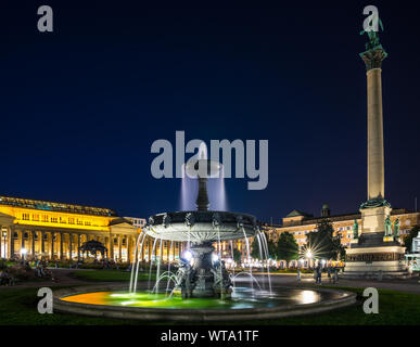 Stuttgart, Germany, August 25, 2019, Downtown schlossplatz square, palace square with illuminated water fountain next to memorial monument surrounded Stock Photo