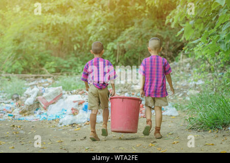 Male Students help to remove rubbish from the classroom to pile waste Stock Photo