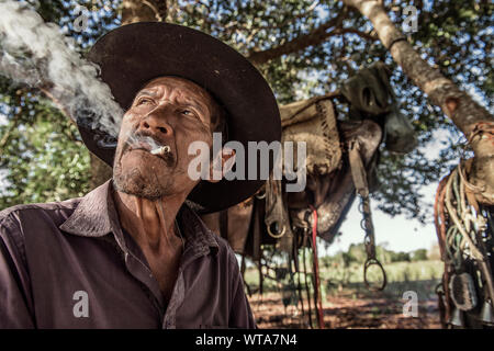 Pantaneiro smoking after a long ride in Pantanal Stock Photo