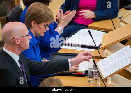 Edinburgh, UK. 5 September 2019. Pictured: (L-R) John Swinney - Depute First Minister; Nicola Sturgeon MSP - First Minister & Leader of the Scottish National Party.  First Ministers Questions in the chamber takes place after the summer break.  Colin Fisher/CDFIMAGES.COM Stock Photo