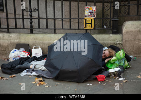 Homeless While Raining A homeless man in the rain on a bench with an umbrella on Via dei Fori ...