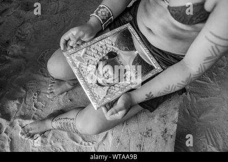 Reflection in a mirror of indigenous woman Stock Photo