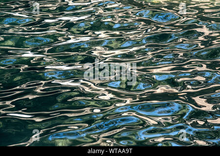 Waterfall water reflecting the sky and the forest Stock Photo