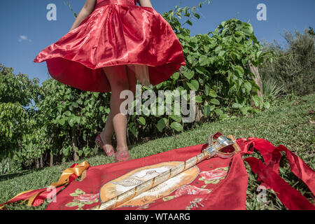 Girl in red dress dancing during revelry of kings Stock Photo