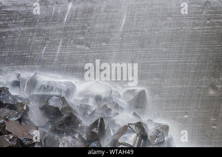 The Snow Waterfall waters falling in high volume on rocks Stock Photo