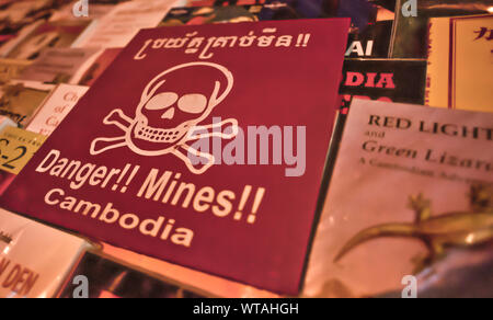 Land mine warning sign to sell in a street book store Stock Photo