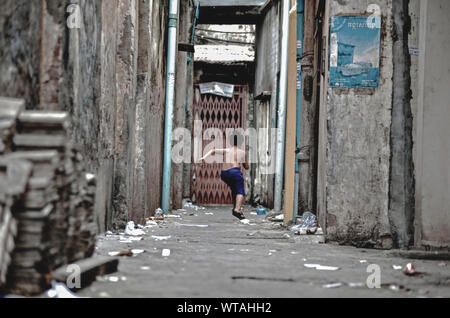 Kid runs back home through the streets alleys Stock Photo