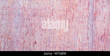 Grunge background. Peeling paint on an old wooden background. Colorful rusty weathered wood planks. Stock Photo