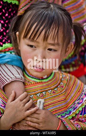 Young girl wearing traditional clothes holding her mother's hand Stock Photo