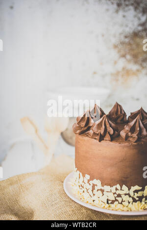 Chocolate cake on the kitchen table ready to eat Stock Photo