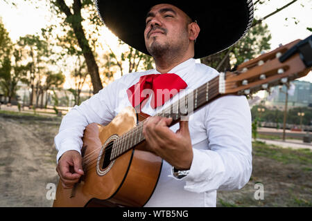 Mexican musicians mariachi playing the guitar Stock Photo