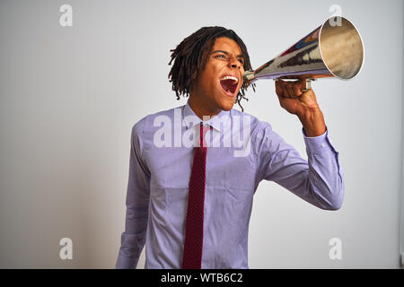 Young african american businessman screaming using vintage megaphone Stock Photo