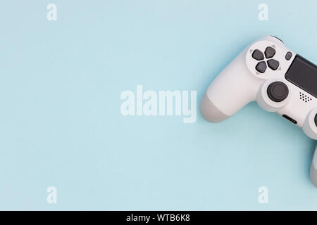 Video games white gaming controller isolated on blue color background top view Stock Photo
