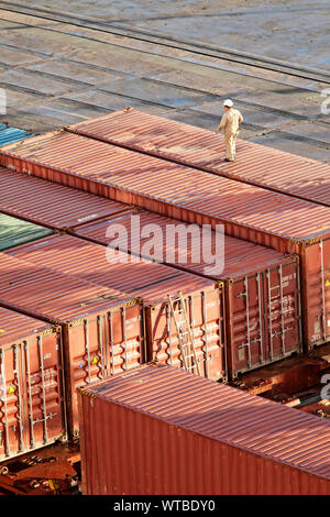 man walking on shipping containers, overhead view Stock Photo