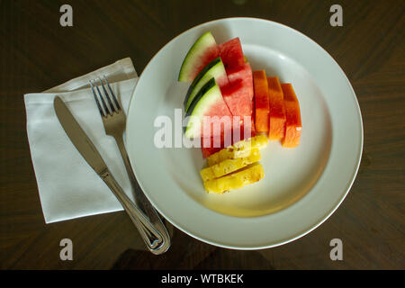 View of fruit platter along with fork and knife Stock Photo
