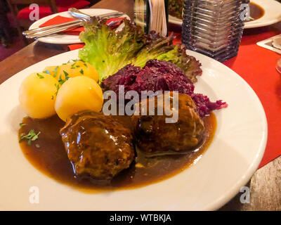 Tasty stewed meat, red cabbage and potato dumplings. Photo Studio Stock Photo