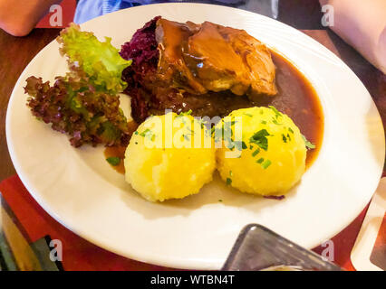 Tasty stewed meat, red cabbage and potato dumplings. Photo Studio Stock Photo