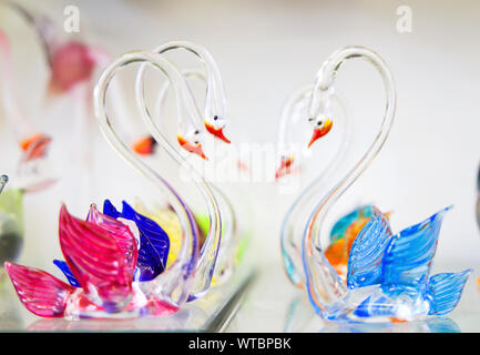 Beautiful crystal swans, Close up with selective focus and neutral soft background, Soft focus. Stock Photo