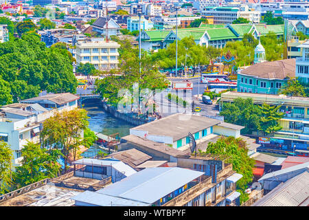 BANGKOK, THAILAND - APRIL 24, 2019: The urban scene in central Bangkok with confluence of khlongs (canals) and moving cars on Phan Fa Lilat Bridge, on Stock Photo