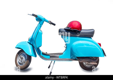 Retro scooter, Vintage scooter, retro motorcycle with red helmet isolated on white background with clipping path. Stock Photo