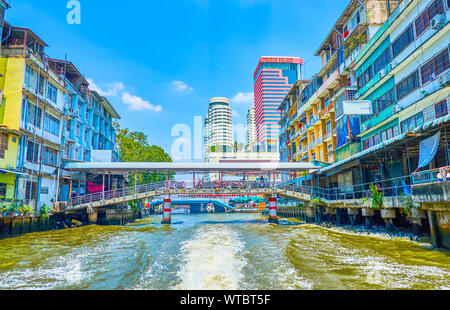 BANGKOK, THAILAND - APRIL 24, 2019: The Saensaep khlong leads through modern district of the city with residential houses,  numerous bridges and high Stock Photo