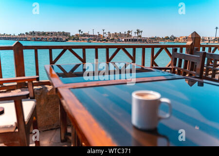 blurry Coffee in front of a lagoon El Gouna beach, Red Sea, Egypt Stock Photo