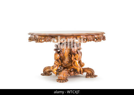 round table decorated with carved figures of angels on white background Stock Photo