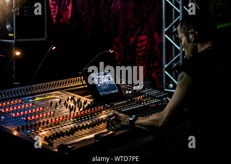 Man working in a sound mixer in a concert at Costao do Santinho Resort. Florianopolis, Santa Catarina, Brazil. Stock Photo