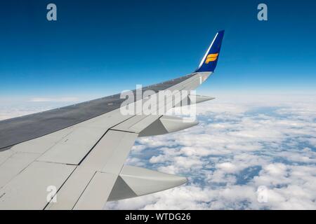 Wing, aircraft from IcelandAir over cloudy sky, Iceland