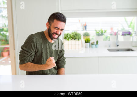 Handsome man celebrating and cheering with excitement expression, smilling for winning success Stock Photo