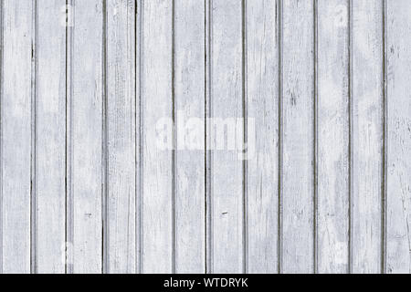 Wooden white painted palisade. Old shabby rustic fence with nails. Vintage gray wood texture, planks background. Stock Photo