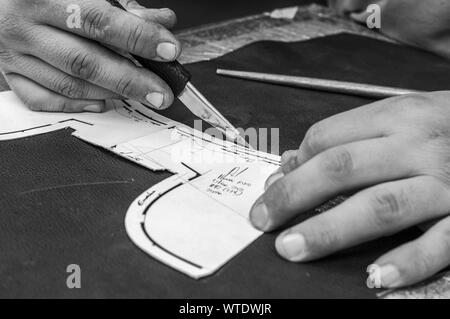 Modelling design of shoes in workplace of shoe designer working on a shoe design Stock Photo