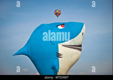 hot air balloon with the shape of a shark isolated on the sky in