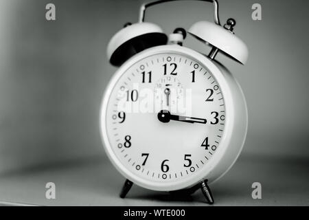 Photo of a retro alarm clock in black and white. Stock Photo