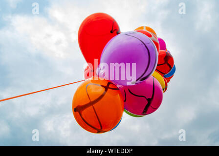 Bunch of multicolored balloons in the city festival. Selective focus. Stock Photo