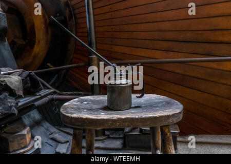 Oil can in engineers workshop. Stock Photo