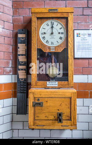 Clocking in clock in factory entrance Stock Photo