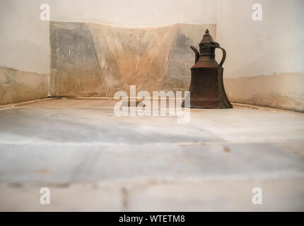 A traditional Turkish Vintage metal ewer or pitcher copper water container in Toliet. selective focus. Stock Photo