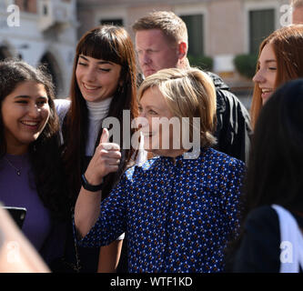 Venice, Italy. Former first lady and US Secretary of State Hillary Clinton is sitting on the artistic installation of American artist Kenneth Goldsmith Stock Photo