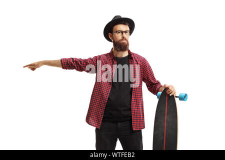 Bearded male hipster holding a longboard and pointing in one direction isolated on white background Stock Photo