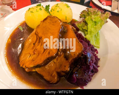 Tasty stewed meat, red cabbage and potato dumplings. Photo Studio Stock Photo