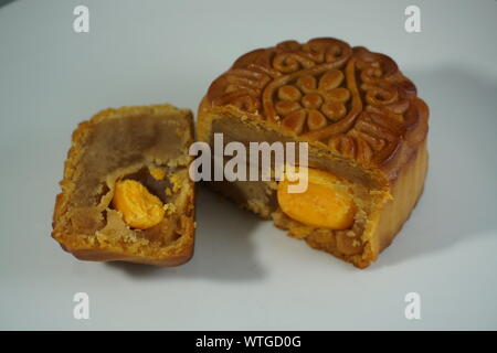 Double egg yolk and lotus seed paste moon cakes for Mid-Autumn Festival celebrated in Chinese culture. Stock Photo