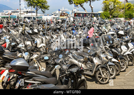 SORRENTO, ITALY - AUGUST 2019: Rows of motorbikes and scooters parked near the port in Sorrento. Stock Photo