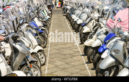 SORRENTO, ITALY - AUGUST 2019: Rows of motorbikes and scooters parked near the port in Sorrento. Stock Photo